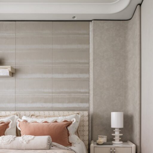 Modern Interior Design Is Seen In This Serene Bedroom. Textured Walls, A Curved Headboard With Scallop Details, And Soft, Neutral Bedding Create A Tranquil Space. A Minimalist Nightstand And Lamp Complete The Look.
