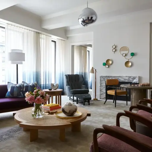 A Cozy Room Blends Colors With Elegance. Soft Light, Comfy Chairs, And Pretty Decorations Make It A Welcoming Space.