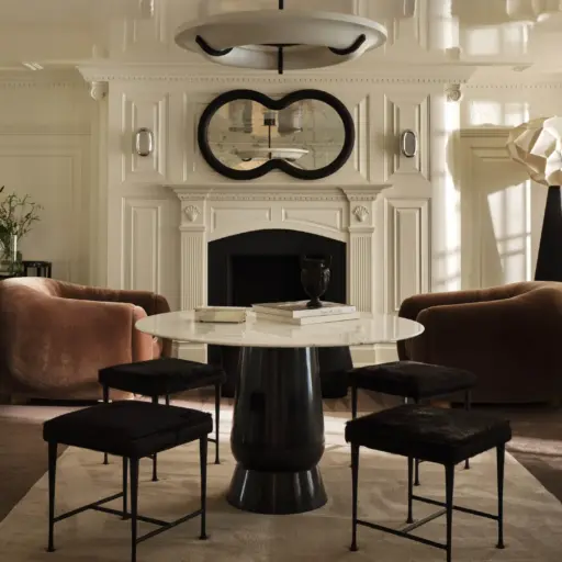 Luxury Interior Design Room With Cream Molding Walls And With Large Windows And With An Antique Fireplace And With Two Brown Velvet Armchairs And With A Round Black Table And With A Cream Rug