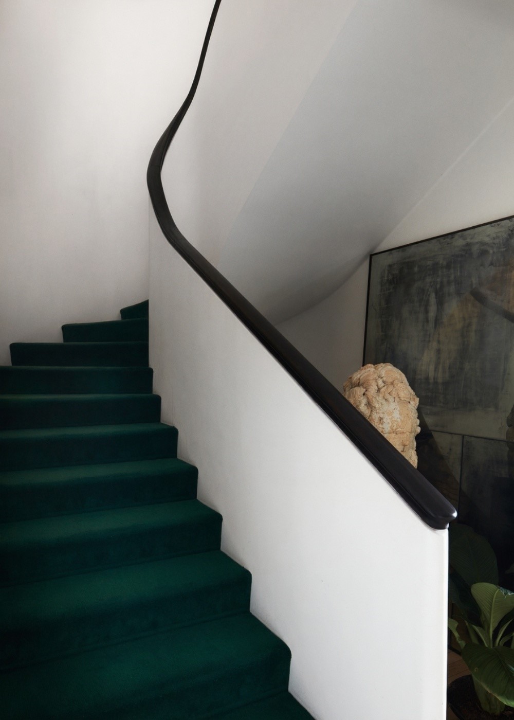 A Runner-Style Patterned Rug Wraps Each Step, Creating A Rhythmic Sense Of Movement.