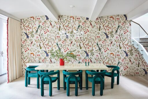 The Living Room Features A Graphic, Colorful Rug That Grounds The Space. The Colorful Rug Interacts Dynamically With Plush Velvet Seating, Sculptural Side Tables, And A Medley Of Curated Art Pieces.