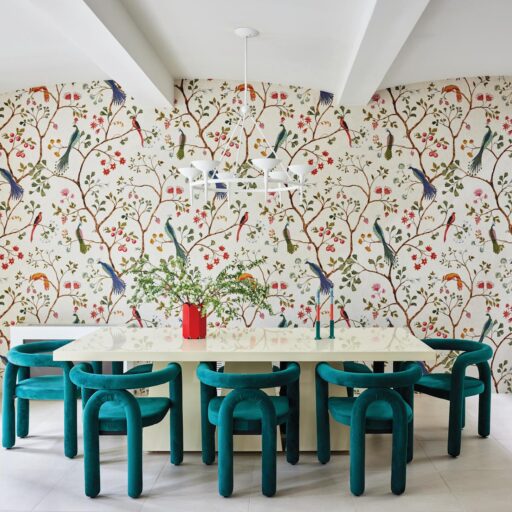 The Living Room Features A Graphic, Colorful Rug That Grounds The Space. The Colorful Rug Interacts Dynamically With Plush Velvet Seating, Sculptural Side Tables, And A Medley Of Curated Art Pieces.