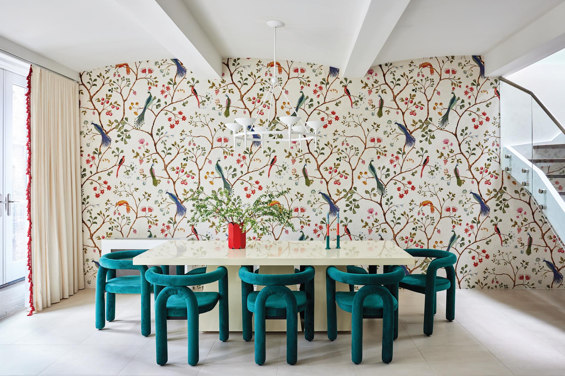 The Living Room Features A Graphic, Colorful Rug That Grounds The Space. The Colorful Rug Interacts Dynamically With Plush Velvet Seating, Sculptural Side Tables, And A Medley Of Curated Art Pieces.