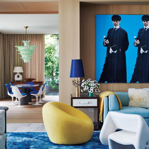 Contemporary Interior Design Living Room With Wood Walls And With A Large Canvas Painting On The Walls And With A Deep Blue Rug And With A Yellow Armchair And With Large Sofas