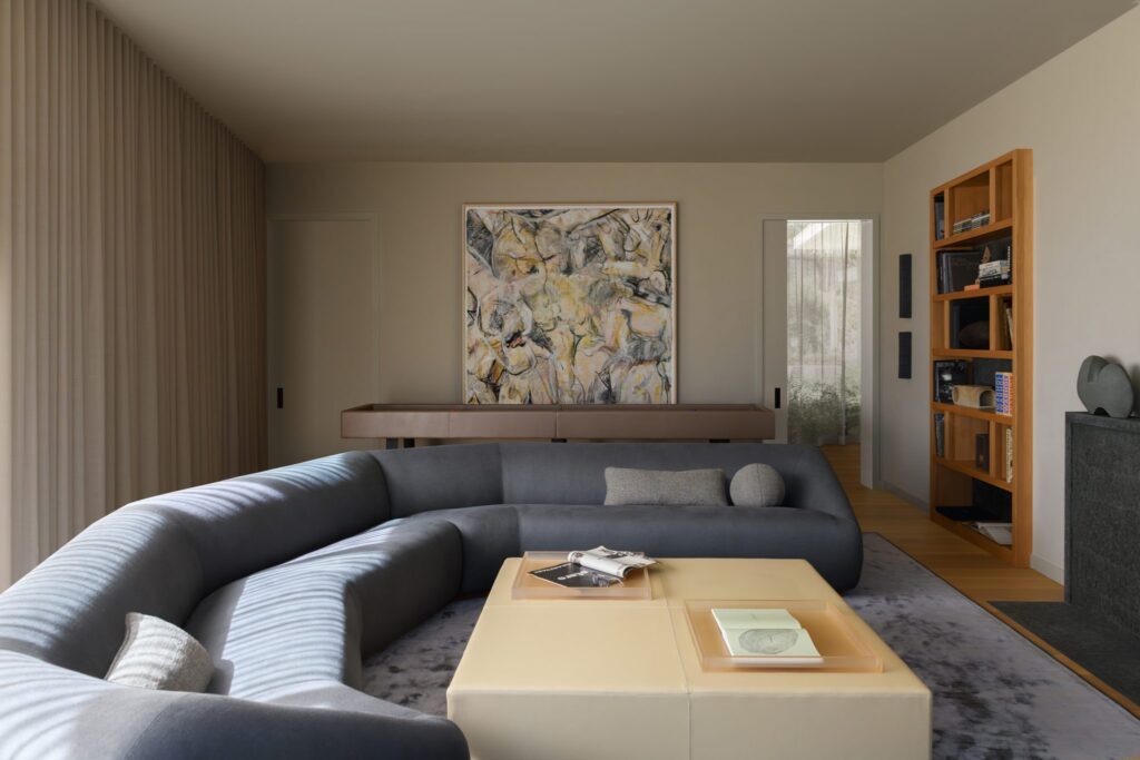 Bright Living Room Featuring A Custom-Made Rounded Sofa, A Unique Custom Rugs, And A Rectangular Coffee Table Centered In The Space, All Bathed In Natural Light