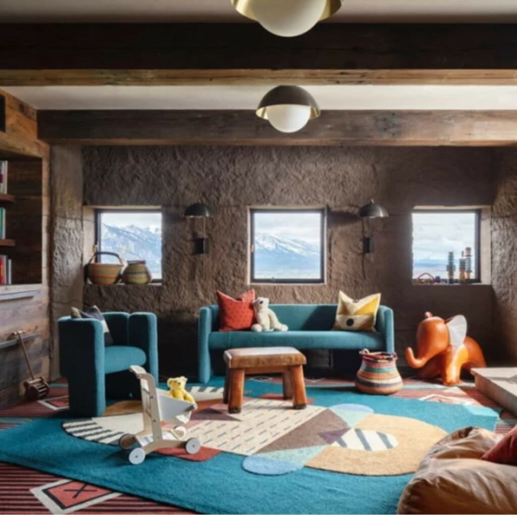 Kids Room With Blue Sofa And Colorful Rug With Orange And Blue
