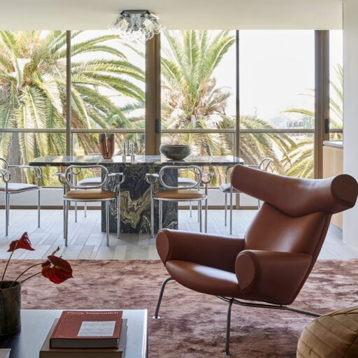 Modern Interior Design Living Room With An Open Space Layout And With Big Windows And With A Brown Armchair
