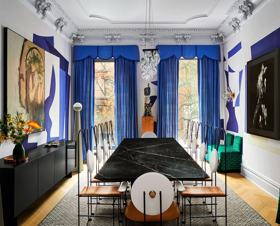 Eclectic Dining Room With A Marble Table And Leather Chairs