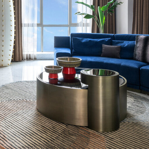 Luxe Living: Curved Blue Velvet Sofa, Sculptural Tables, And A Striped Rug Define This Modern Space. A Masterclass In Hospitality Interior Design.