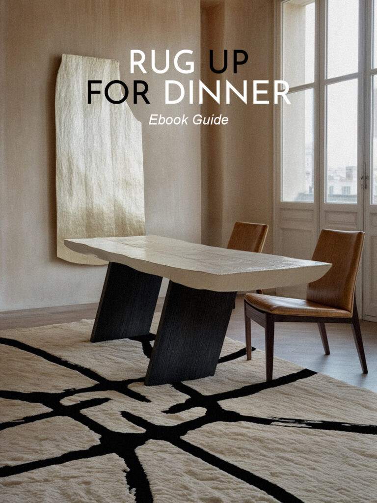Modern Dining Room With Abstract Black And White Rug, Sculptural Dining Table, And Leather Chairs In A Neutral-Toned Interior.